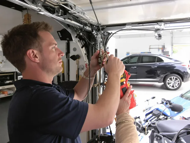 Foxborough Garage Door Repair safety certified technician performing cable replacement in Foxborough
